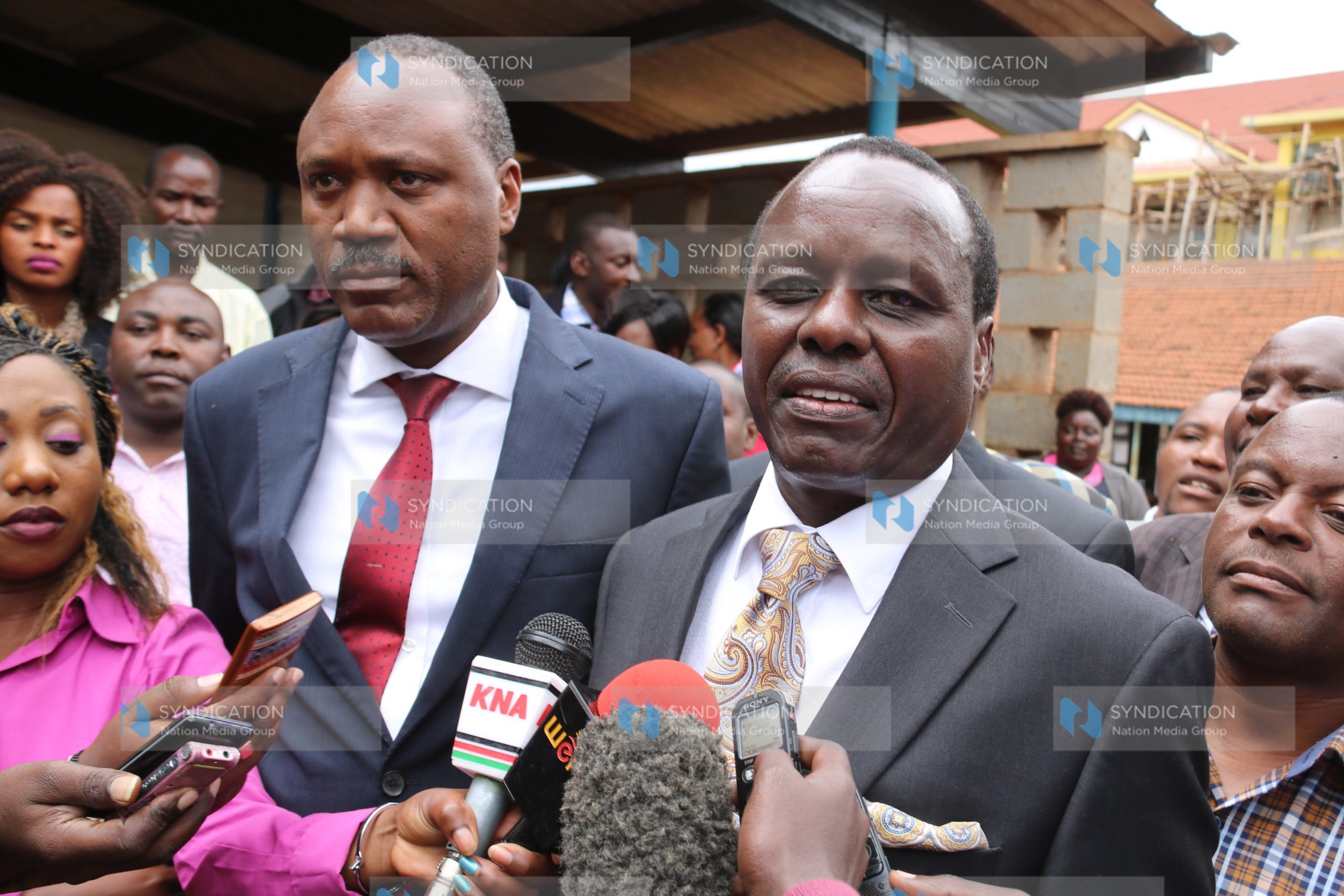 Senator Lenny Kivuti (right) address the press while flanked by his lawyer Wilfred Nyamu (in red tie) after leaving the Embu High court