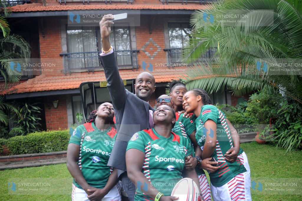 Sportpesa Chief Executive Officer Ronald Karauri with Ladies, National seven aside Rugby Teams players