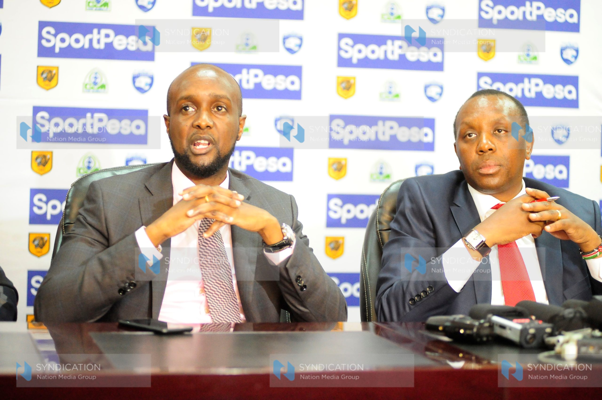 Sportpesa Chief Executive Officer Ronald Karauri with Sports Permanent Secretary Nderitu Kaberia