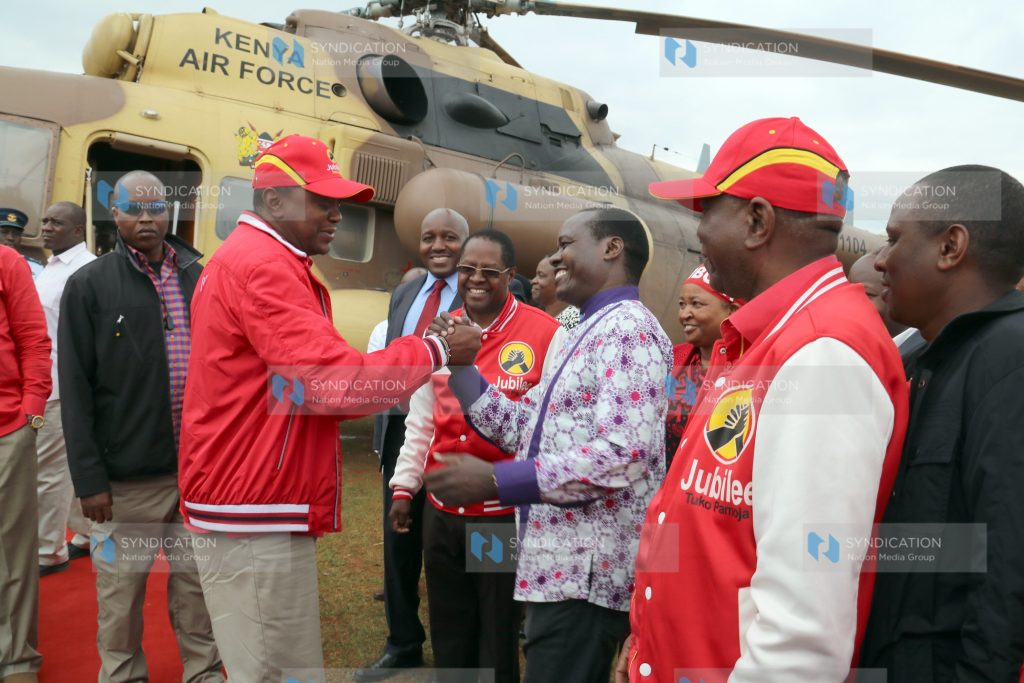 President Uhuru Kenyatta is received by Embu Senator Lenny Kivuti at King David High School, Kamama, before addressing a rally