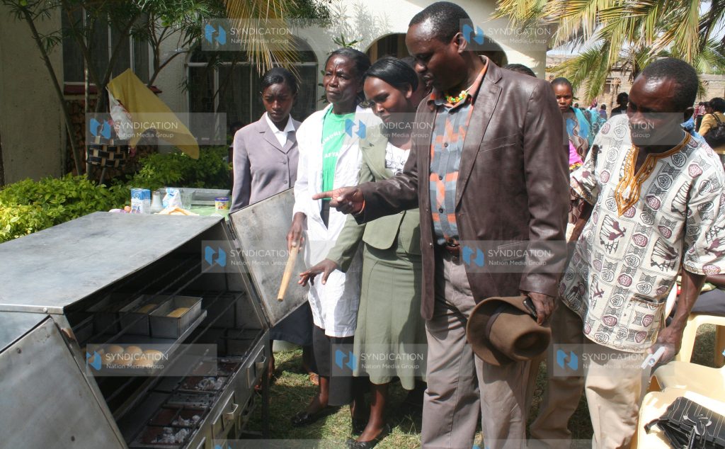 Siakago MP Lenny Kivuti is taken around a demonstration bakery during an exhibition by a women's group