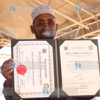 Mohamed Adan Khalif displays a certificate