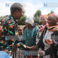 Molo MP Kuria Kimani is received by the elderly at DEB Primary School