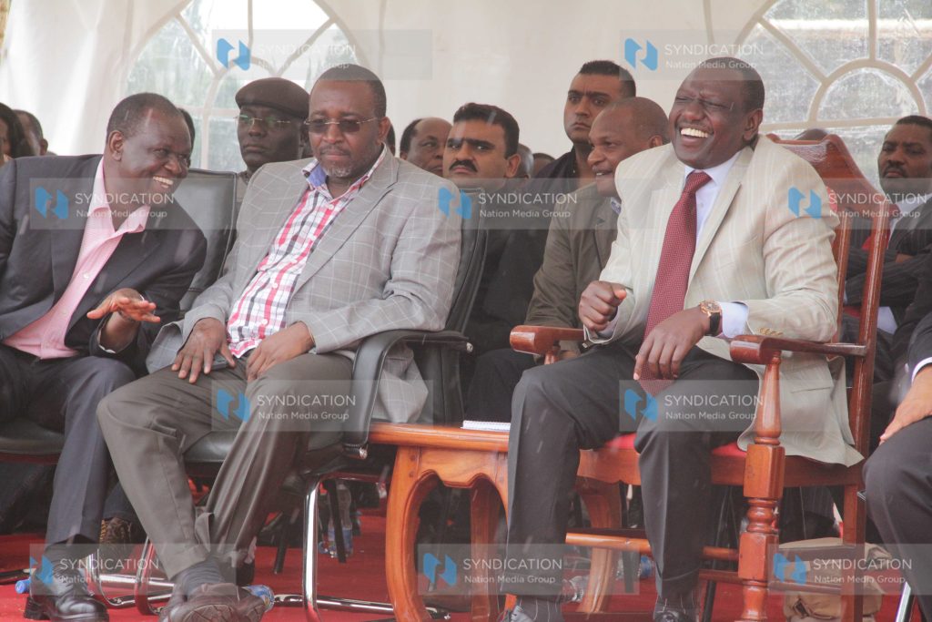 Deputy President William Ruto chats with MP Mithika Linturi and Meru Senator Kiraitu Murungi