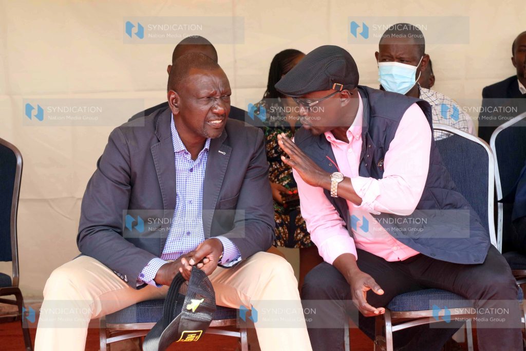 Deputy President William Ruto chats with Edward Muriu, who is aspiring Gatanga MP