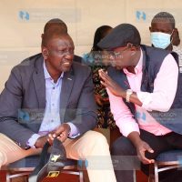 Deputy President William Ruto chats with Edward Muriu, who is aspiring Gatanga MP