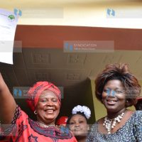 Mary Wambui, left, displays a copy of IEBC certificate