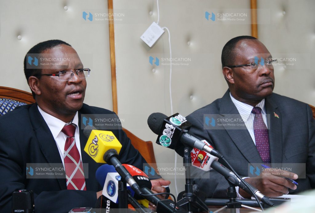 Principal secretary Karanja Kibicho (left) flanked by Political and diplomatic secretary Amb. Robert Ngesu addresses a media