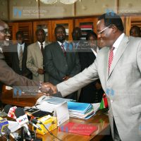 Roads Minister Mr. Franklin Bett, shakes hands with Minister Chris Obure